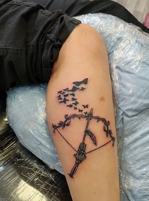 Bow and arrow with a flock of birds flying off the string, fine line