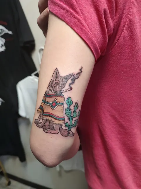 Small dog in a sombrero and serape with a cactus on the arm, in color