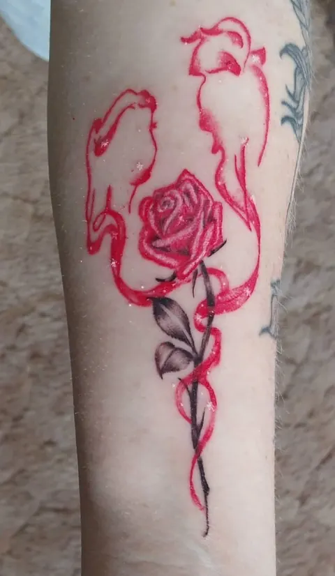 Red rose with a long stem in a loose watercolor style
