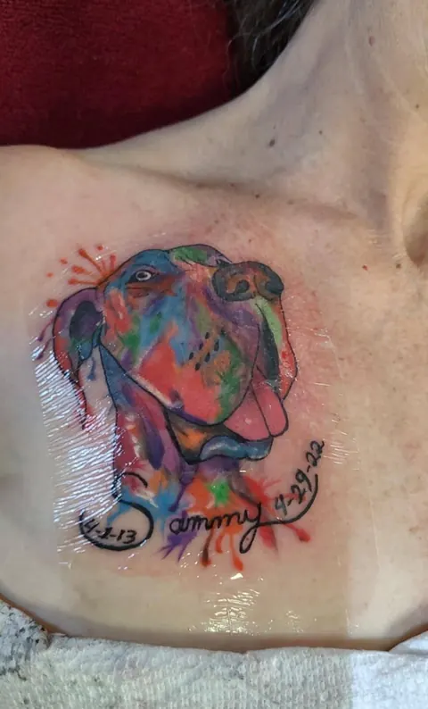Watercolor style dog portrait with a name in script on the chest